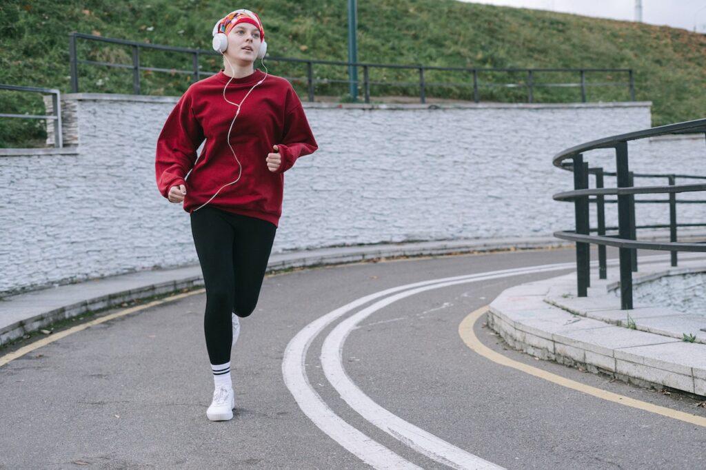 Image of a woman running down the street. Exercise can help with seasonal affective disorder SAD