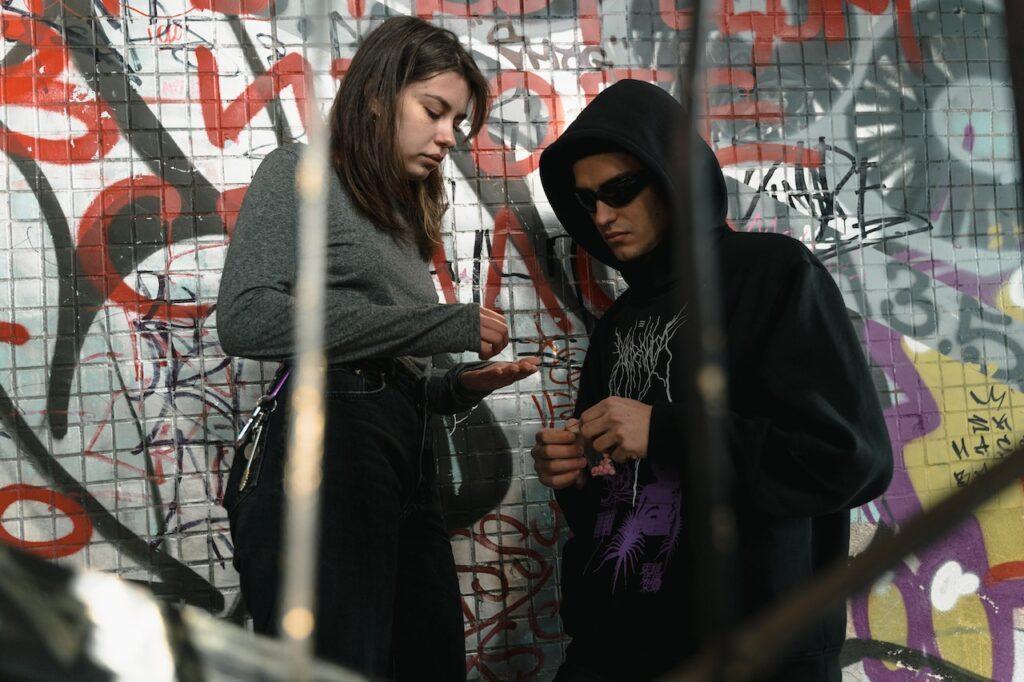County Lines: A Man and a Woman Having a Drug Deal Stock Photo