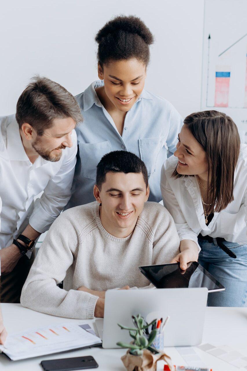 Group of people at a workplace working together. Good reason to start an apprenticeship.