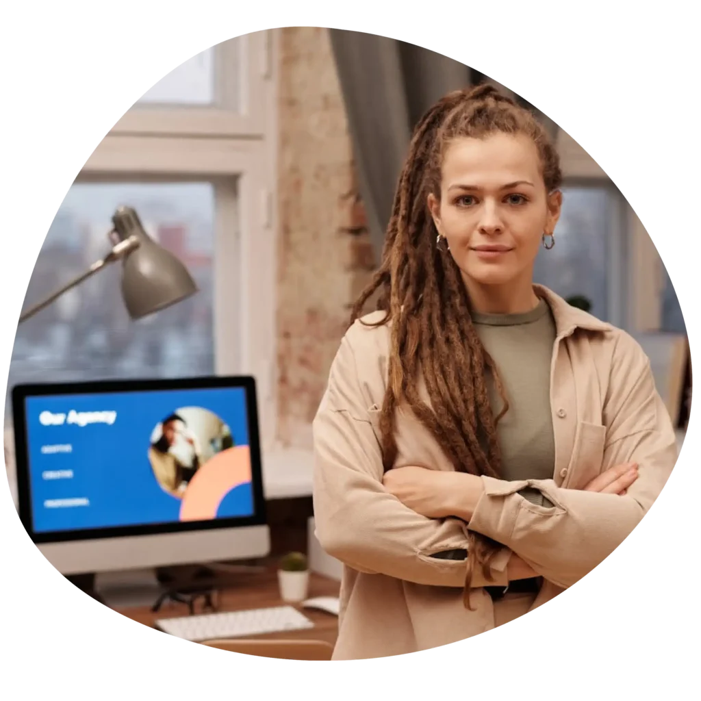 Digital marketing apprenticeships: Photo of a woman stood with her arms crossed with a smile on her face in a digital marketing office