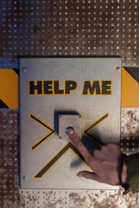 Image of a person pressing a button that says "help me". Having a silent alarm can help with an invacuation or lockdown