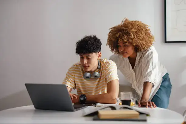 Photo of a mother helping her son search career options.  Apprenticeship Advice for Parents and Carers
