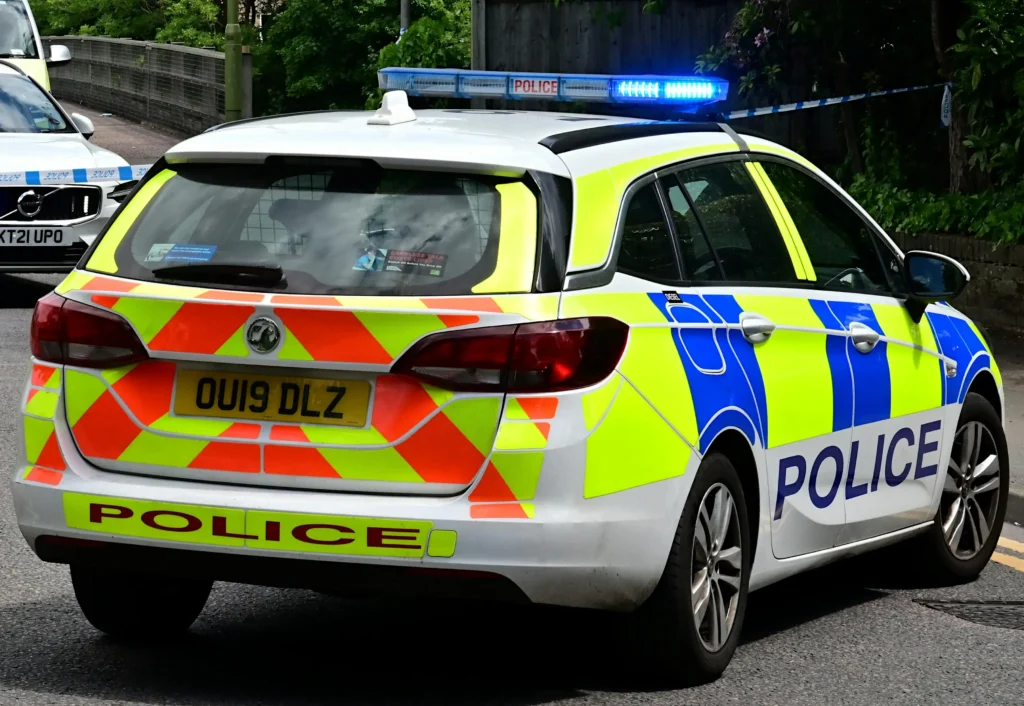 Image of police car in relation to reporting suspicious activity and preventing harm.
