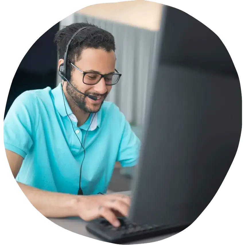 IT Support Apprentice: a man wearing headphones and typing on a computer