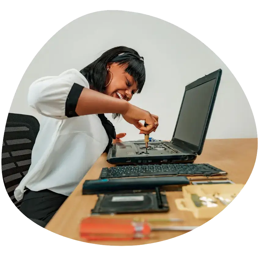 IT Technician Apprenticeship: a woman fixing a laptop keyboard