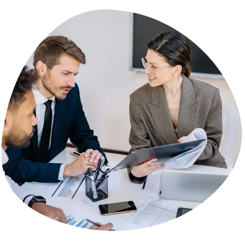 Operations Management Course: a group of people sitting at a table looking at a folder