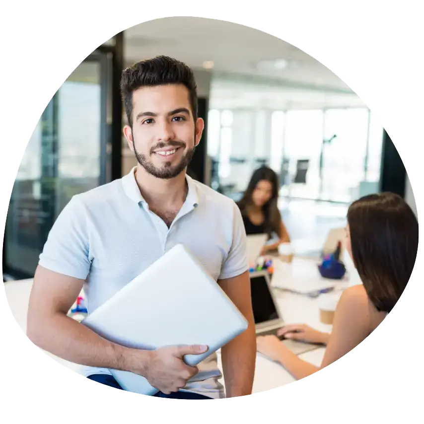 Advanced Learner Loan: Photo of a young male in an office environment holoding a laptop