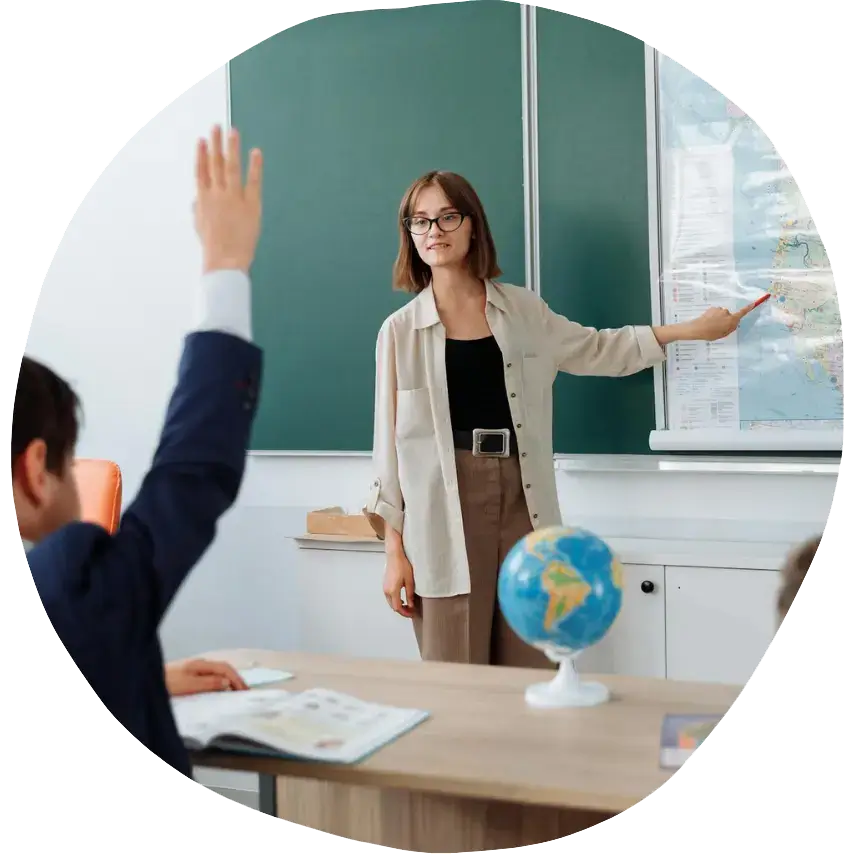 Teaching Assistant Apprenticeship: a woman standing in front of a chalkboard
