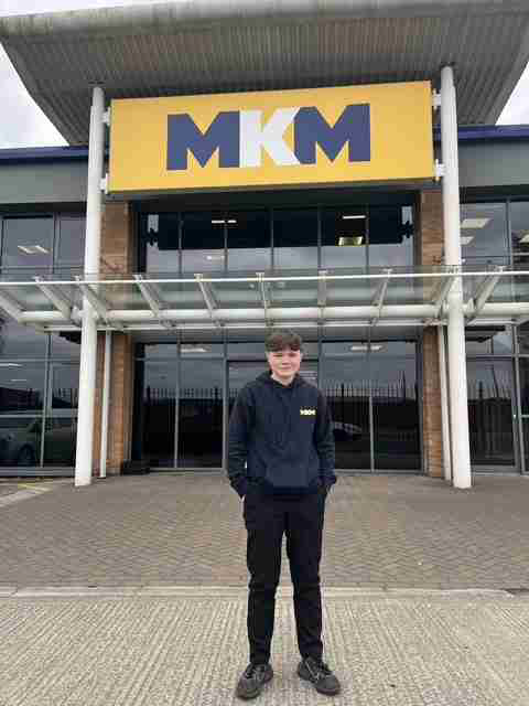 Photo of Louis, who has recently completed his Level 3 Business Administration Apprenticeship with MKM Building Supplies, showing his apprenticeship achievement.