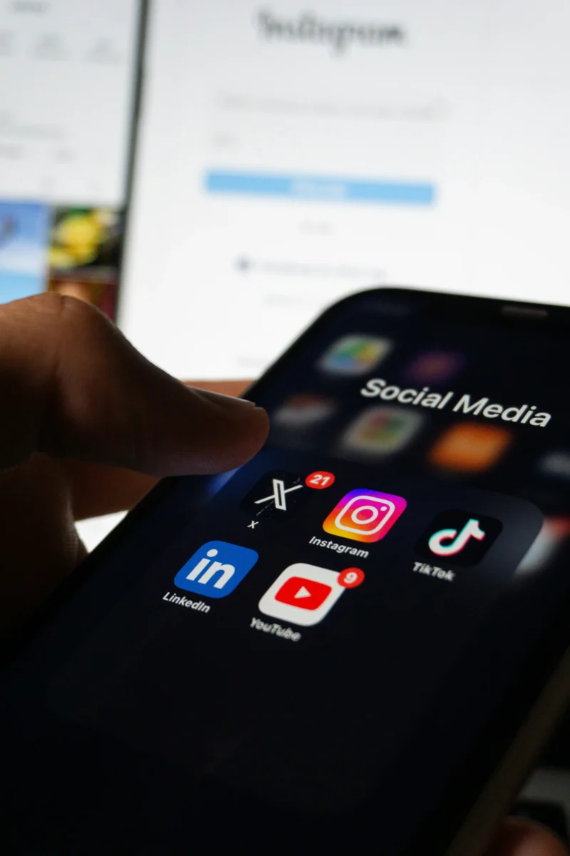 Photo of mobile phone with social media apps. Prevent online influence ad the manosphere issue.